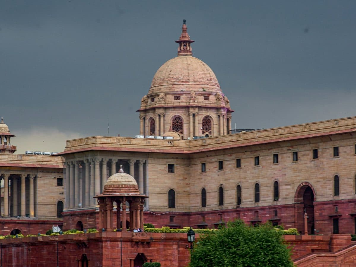 A central government secretariat building in New Delhi under a monsoon sky